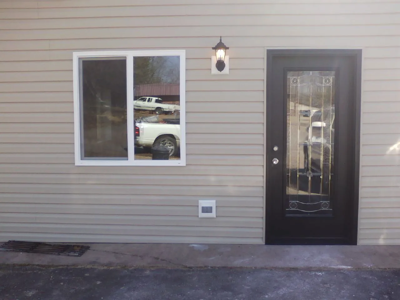 New siding, window and entry door on the side of an addition in Hoodsport